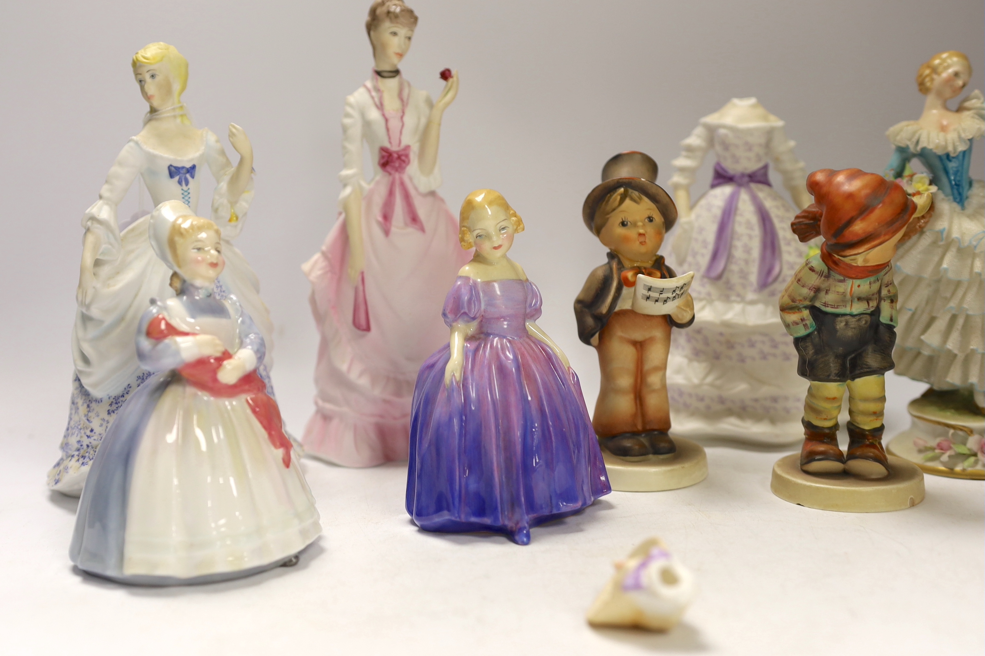 Two Doulton figures, three Worcester figures, Goebel figures and a continental figure